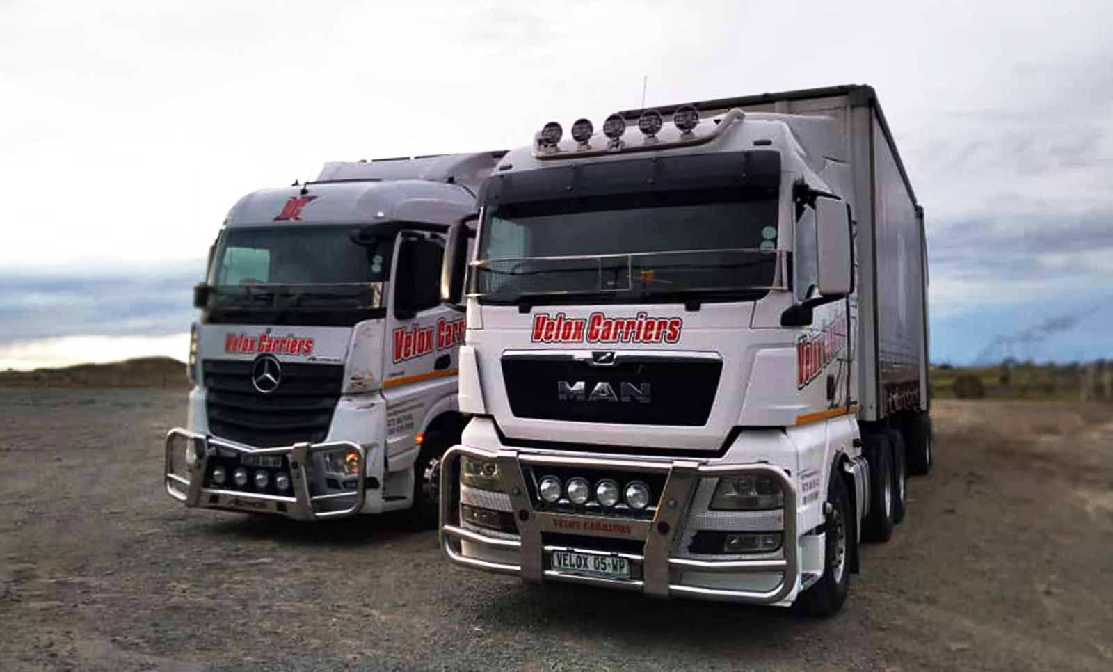 Two large transports parked next to each other